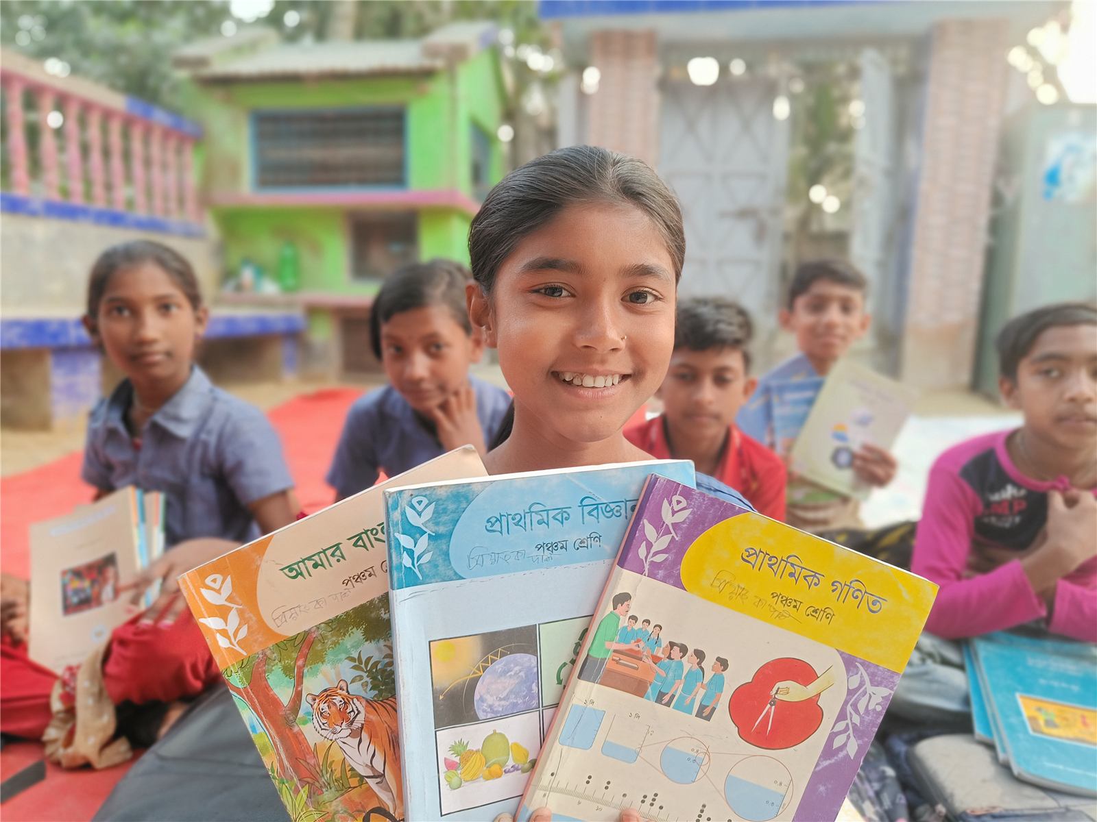 Priyanka holding her school books at The Yahweh Mission School in Gonali