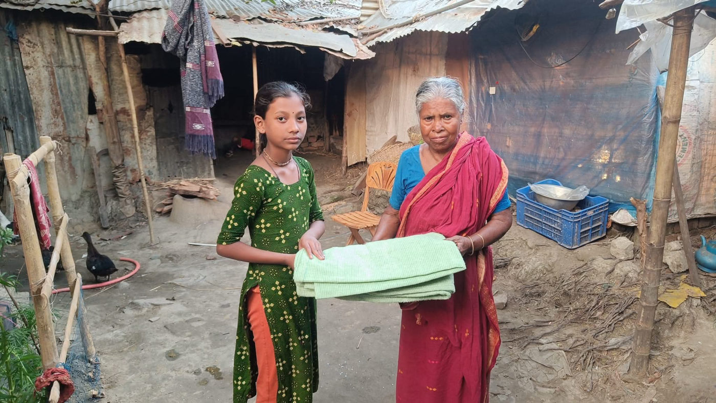 A girl and an older woman holding new blankets