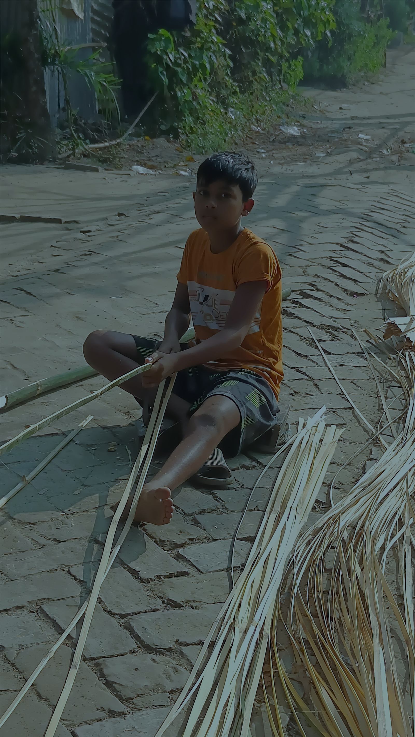 A boy splitting bamboo