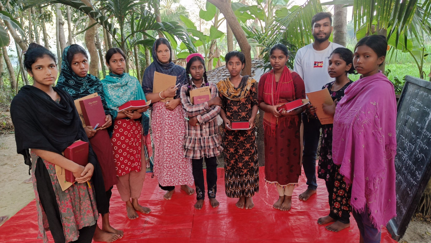Women of Gonali gathered with their books